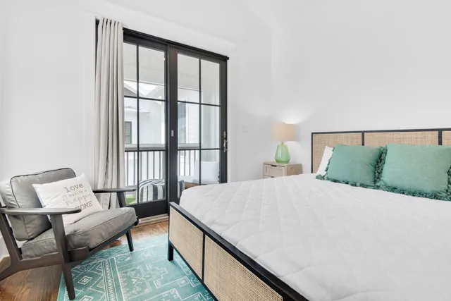 a bedroom with a bed couch and window