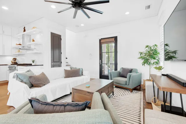 a living room with furniture and a chandelier