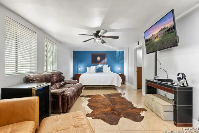 a bed room with two bed and a flat screen tv