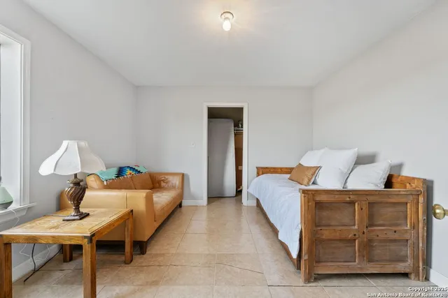 a bed room with a bed and a lamp