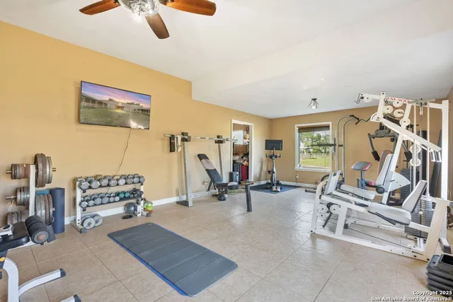 a bedroom with furniture and a large window