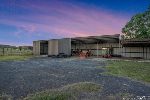 a view of a house with backyard and a trees