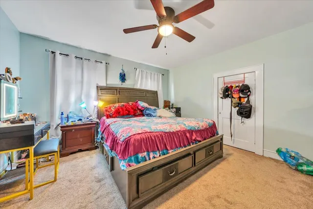 a bed room with a bed and a chandelier