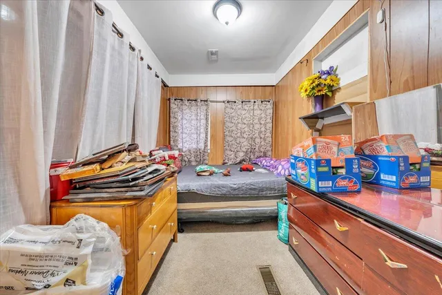 a bedroom with furniture and a chandelier