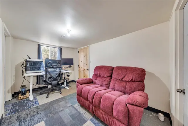 a kitchen with a refrigerator and white cabinets