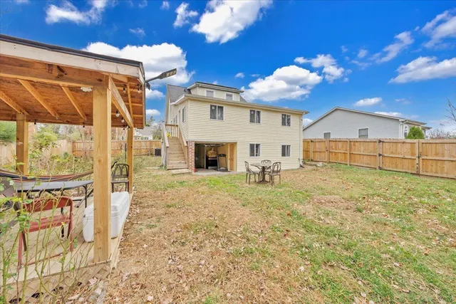 a view of a house with a yard and sitting area