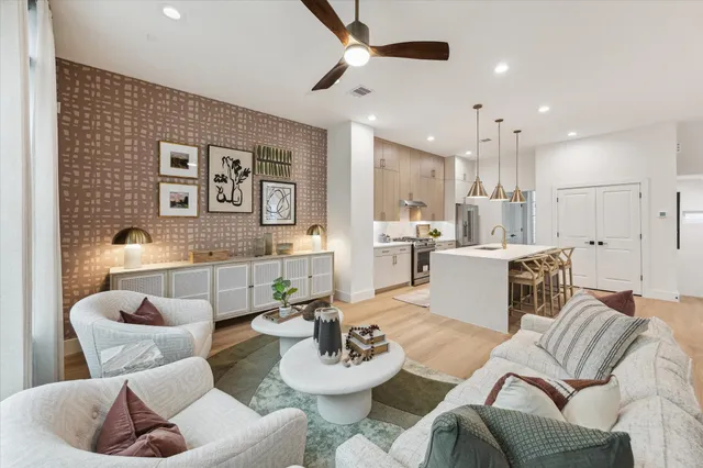 a living room with furniture and kitchen view