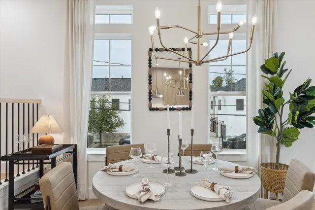 a dining room with furniture potted plants and wooden floor