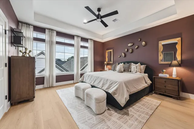 a bedroom with a large bed and a chandelier