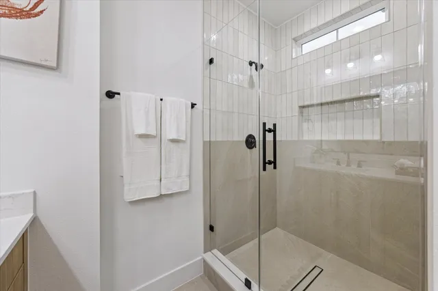a bathroom with a shower and a sink