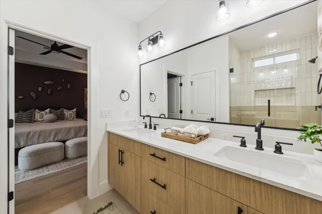 a bathroom with a sink double vanity and a mirror