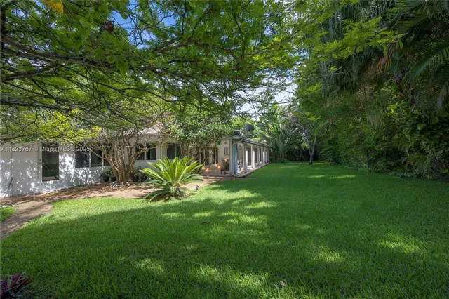 a view of a garden with a bench in a patio