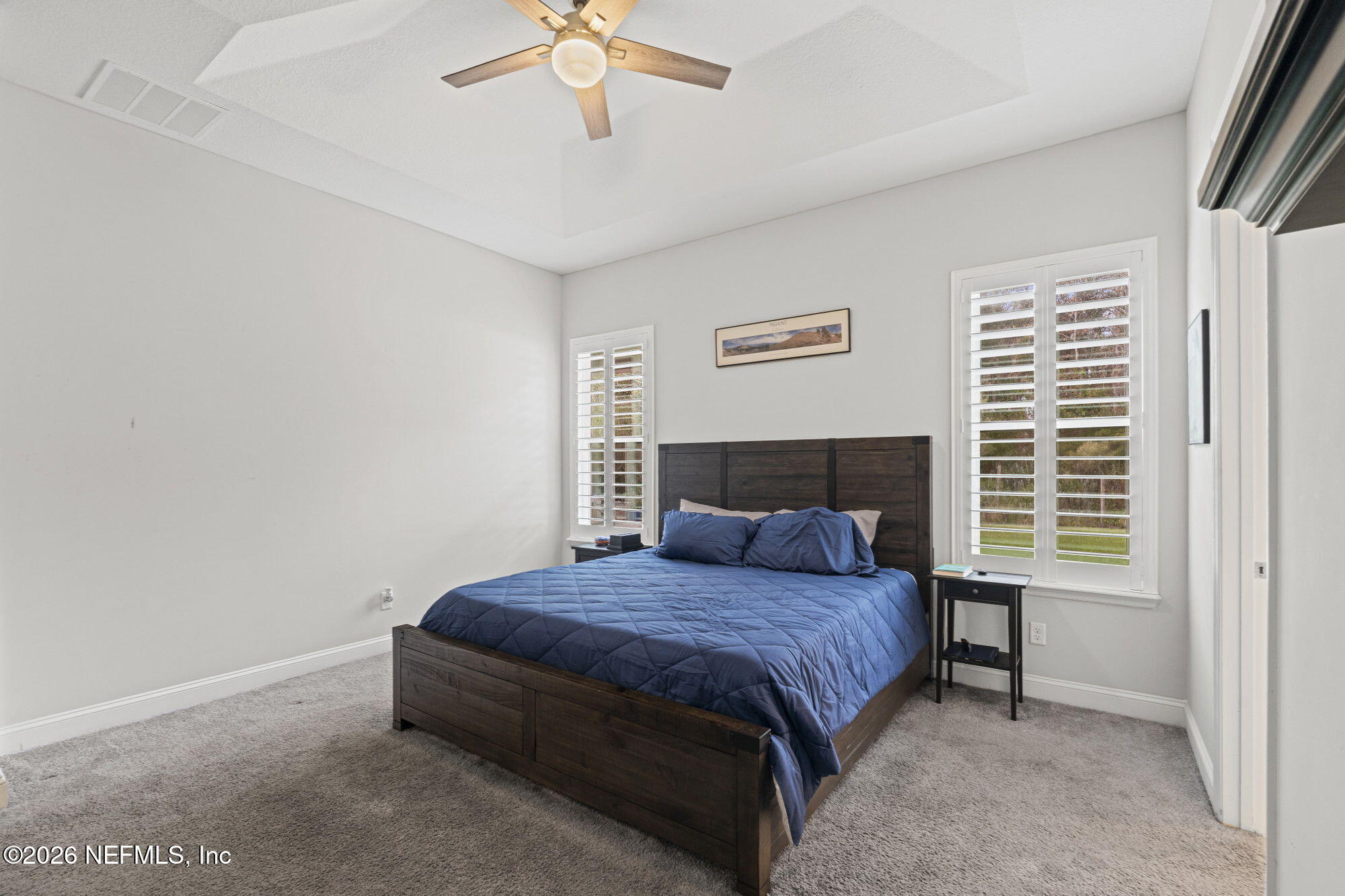 87 Footbridge Road St. Johns, FL 32259 - Photo 17 of 32 a bedroom with a bed and a chandelier