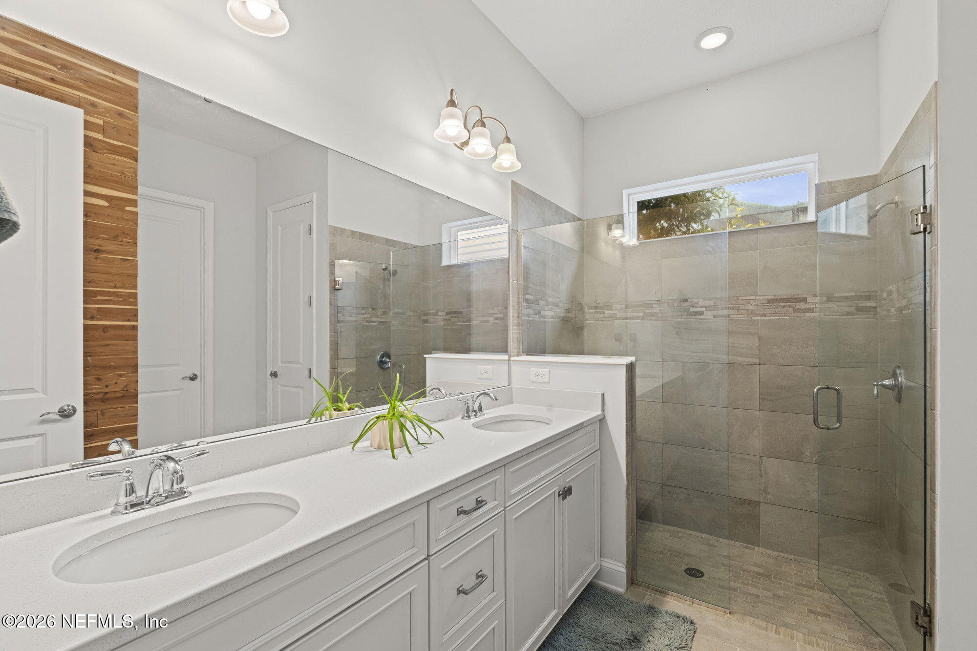 87 Footbridge Road St. Johns, FL 32259 - Photo 20 of 32 a bathroom with a double vanity sink mirror and shower