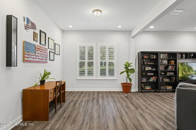 a living room with furniture and wooden floor