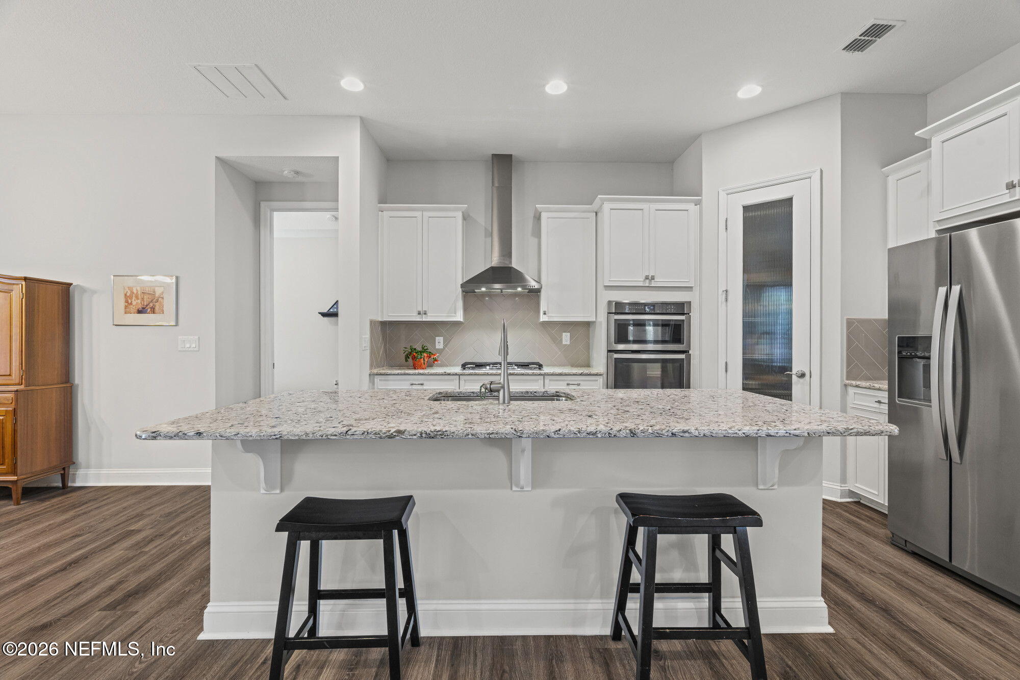 87 Footbridge Road St. Johns, FL 32259 - Photo 8 of 32 a kitchen with stainless steel appliances granite countertop a white cabinets and a refrigerator