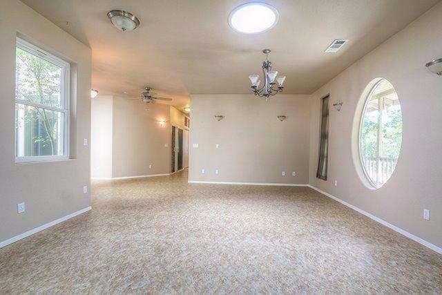 6555 Hugo Road Grants Pass, OR 97526 - Photo 6 of 31 Living area with suntube and windows for