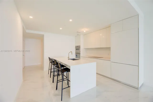 a kitchen with a sink cabinets and appliances