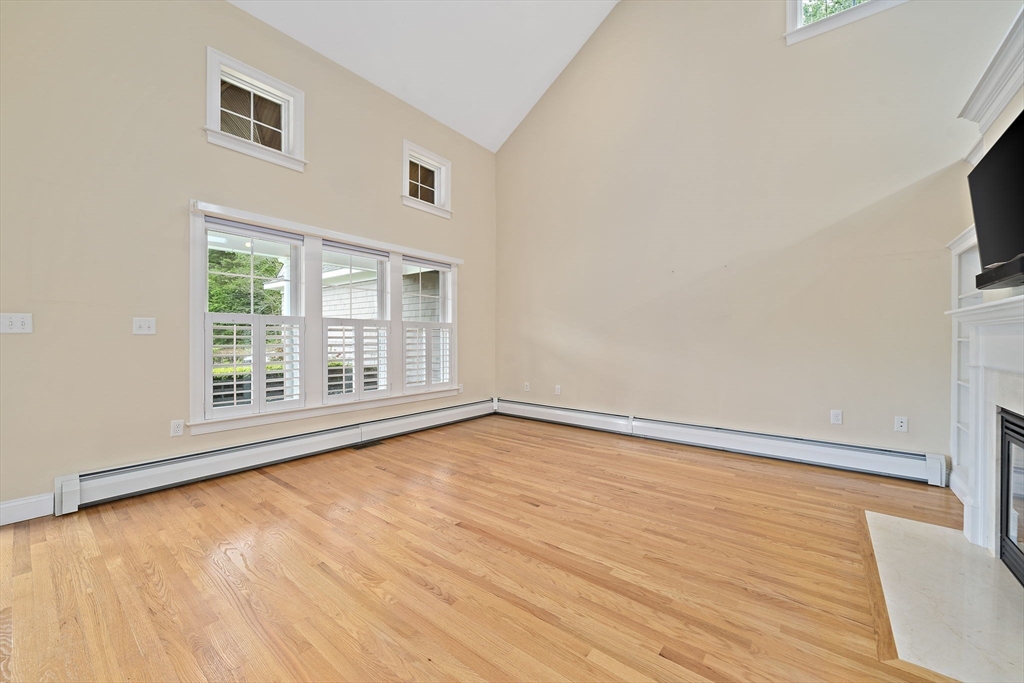 14 Sugar Maple Circle, Unit 14 Hanover, MA 02339 - Photo 7 of 38 a view of an empty room with wooden floor and a window