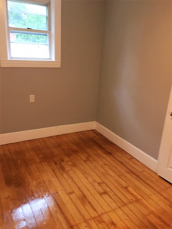 5 Mountfair Terrace Boston, MA 02136 - Photo 11 of 15 an empty room with wooden floor and windows
