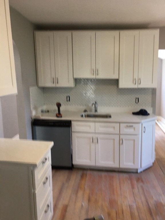 5 Mountfair Terrace Boston, MA 02136 - Photo 4 of 15 a kitchen with granite countertop white cabinets and white appliances