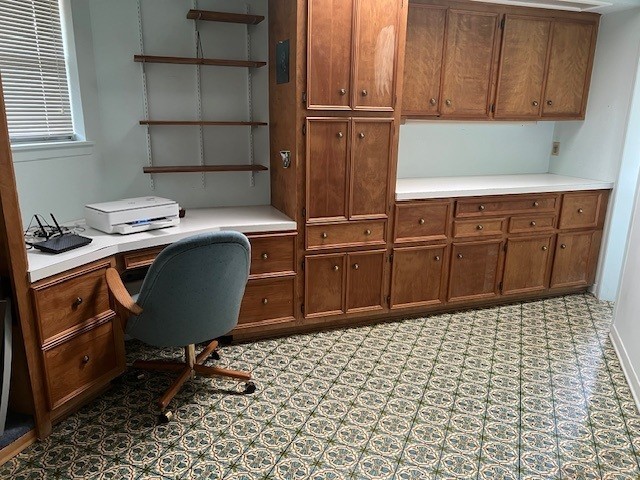 8639 Cedarbrake Drive Spring Valley Village, TX 77055 - Photo 8 of 26 Discover a spacious and functional office area just off the kitchen, featuring a built-in desk and ample storage cabinets, perfect for productivity and organization.