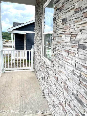 a view of front door of house with wooden floor