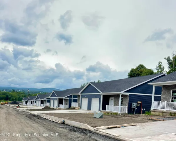 a view of a big house with a big yard and large trees
