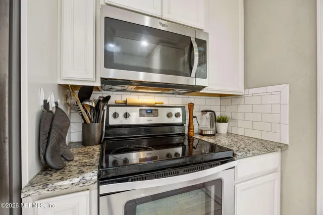 a kitchen with a stove and a microwave