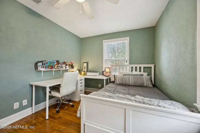 a living room with a stove and a table chair