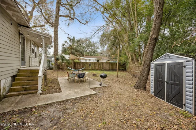 a view of a backyard with sitting area