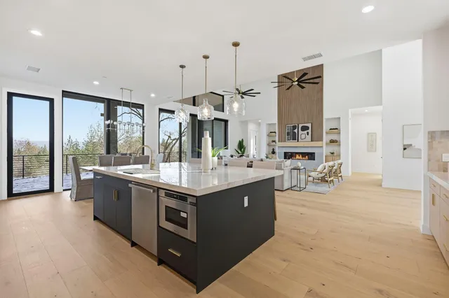 a kitchen with stainless steel appliances granite countertop a sink stove and cabinets