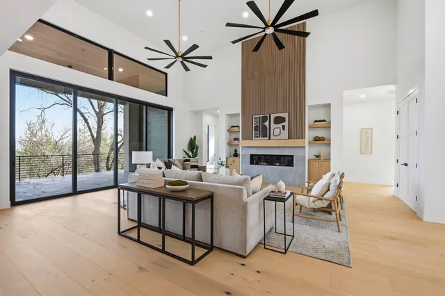a bathroom with a potted plant on the counter and a wooden floor