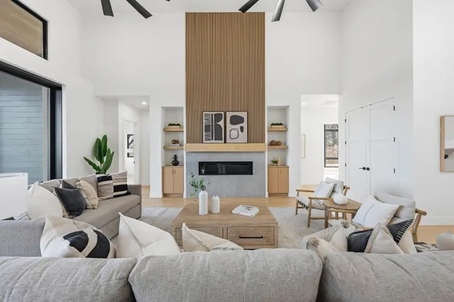 a large white kitchen with a large window and stainless steel appliances