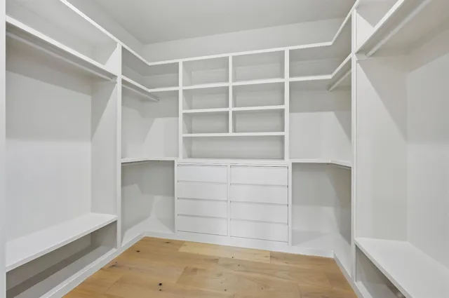a bathroom with a double vanity sink a mirror and a shower