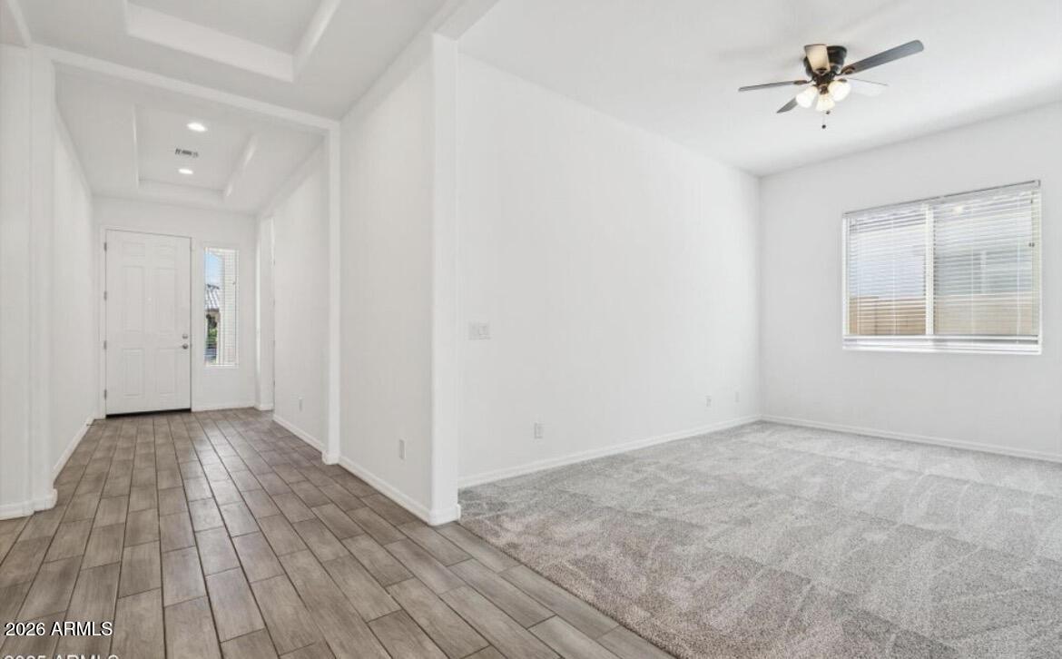 15718 West Adams Street Goodyear, AZ 85338 - Photo 3 of 6 wooden floor in an empty room with a window