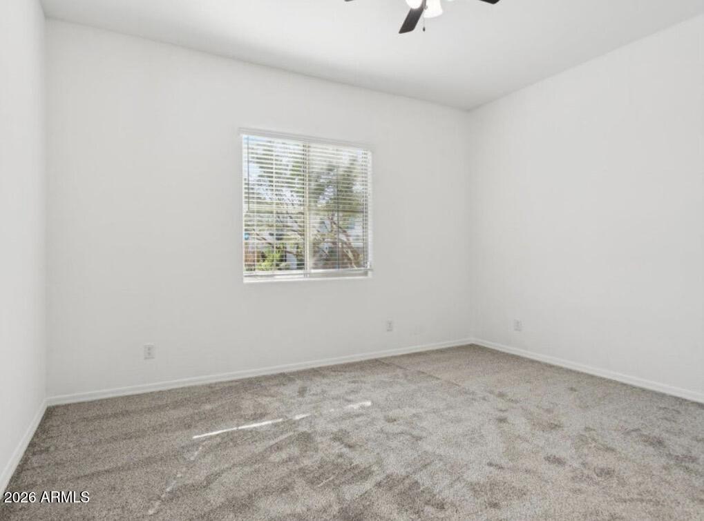 15718 West Adams Street Goodyear, AZ 85338 - Photo 6 of 6 an empty room with a window