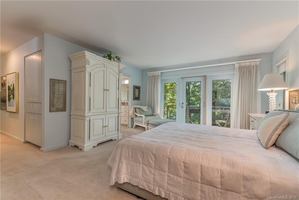 320 Ridgetop Road Tryon, NC 28782 - Photo 19 of 36 a large bed sitting in a bedroom next to a window and a larger closet