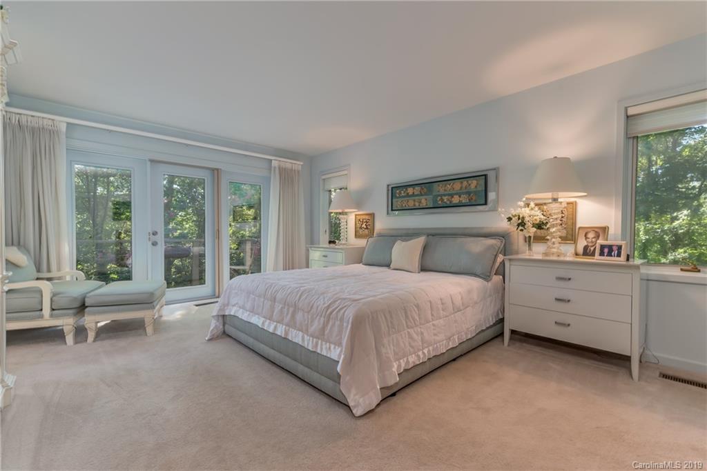 320 Ridgetop Road Tryon, NC 28782 - Photo 20 of 36 a bedroom with a large bed and large windows