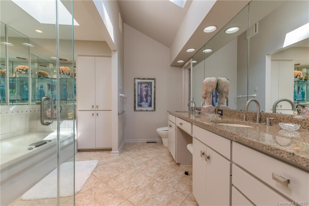 320 Ridgetop Road Tryon, NC 28782 - Photo 21 of 36 a spacious bathroom with a granite countertop sink a toilet and shower