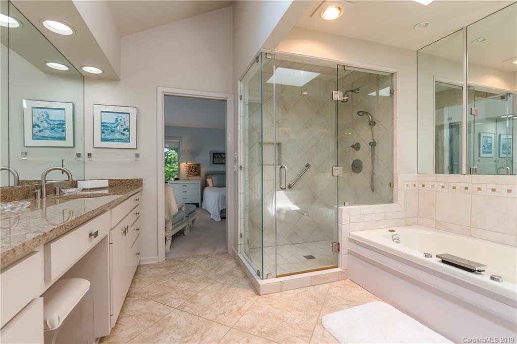 320 Ridgetop Road Tryon, NC 28782 - Photo 22 of 36 a large spacious bathroom with a granite countertop tub mirror and shower
