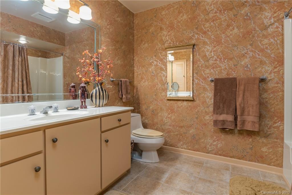 320 Ridgetop Road Tryon, NC 28782 - Photo 26 of 36 a bathroom with a toilet sink and mirror