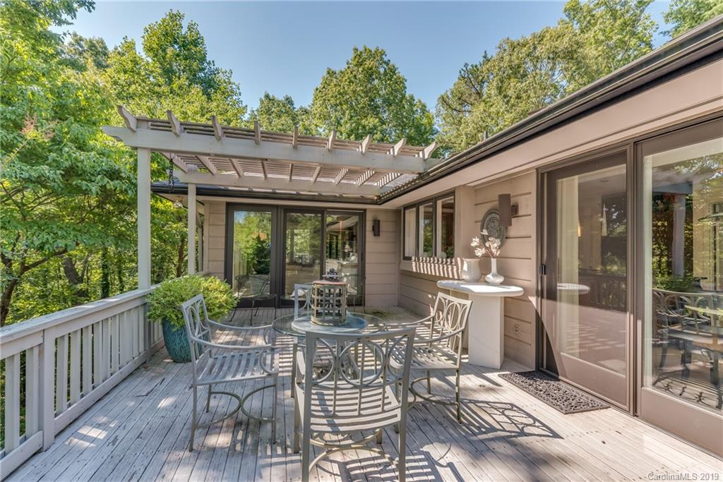 320 Ridgetop Road Tryon, NC 28782 - Photo 29 of 36 a view of a patio with a dining table and chairs