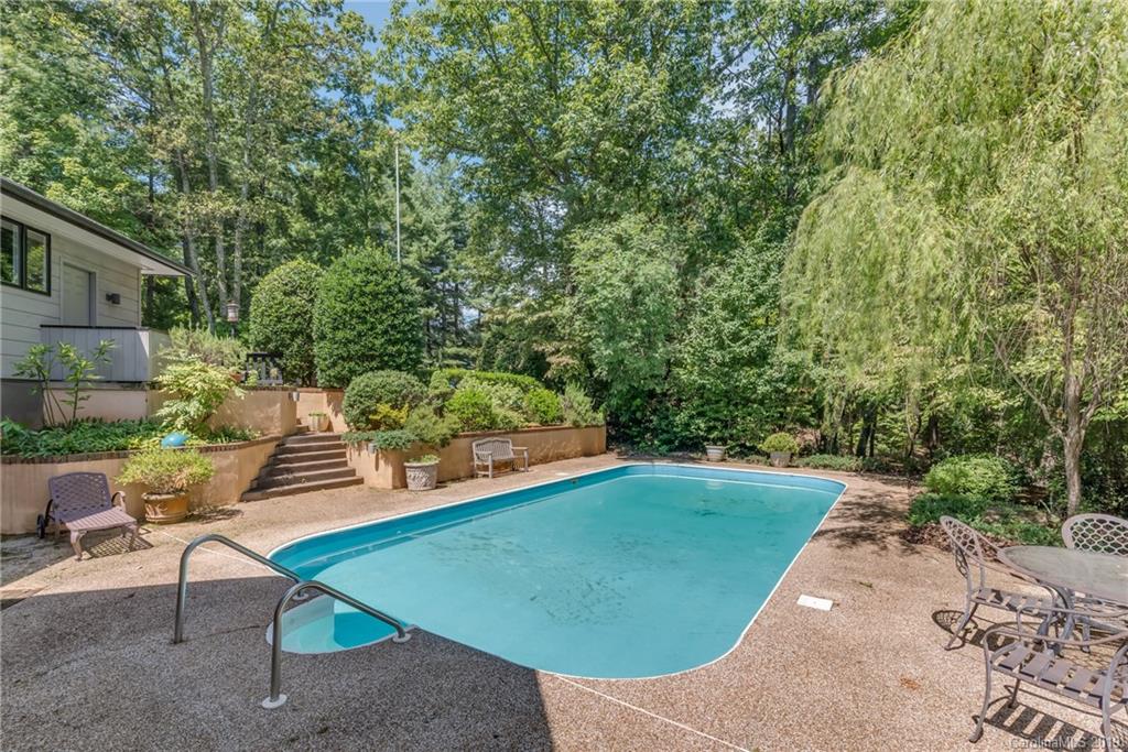 320 Ridgetop Road Tryon, NC 28782 - Photo 33 of 36 a backyard of a house with outdoor seating
