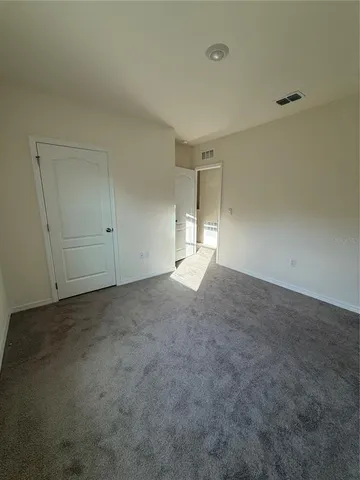 an empty room with a empty space and windows