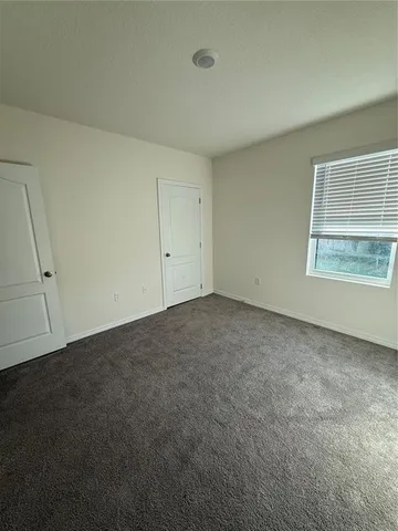 an empty room with a empty space and windows