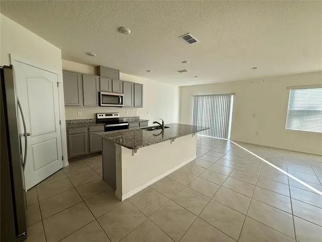 a large kitchen with cabinets and stainless steel appliances