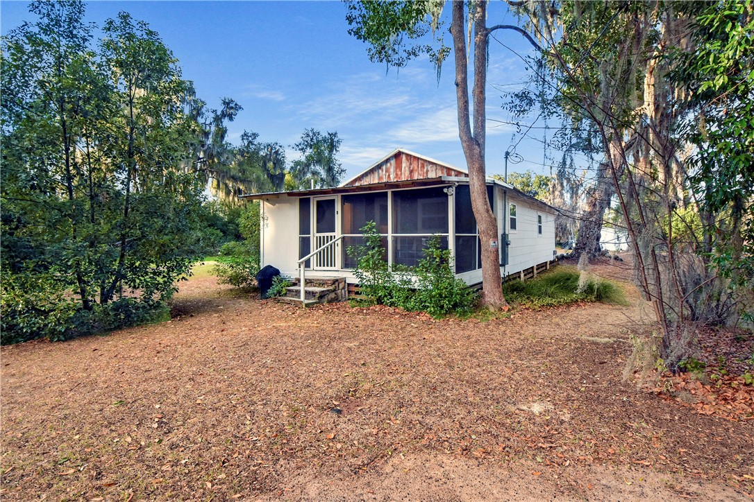 211 Trumbull Street Darien, GA 31305 - Photo 22 of 26 Back yard has a lot of room for a fire pit, additional parking or even a pool