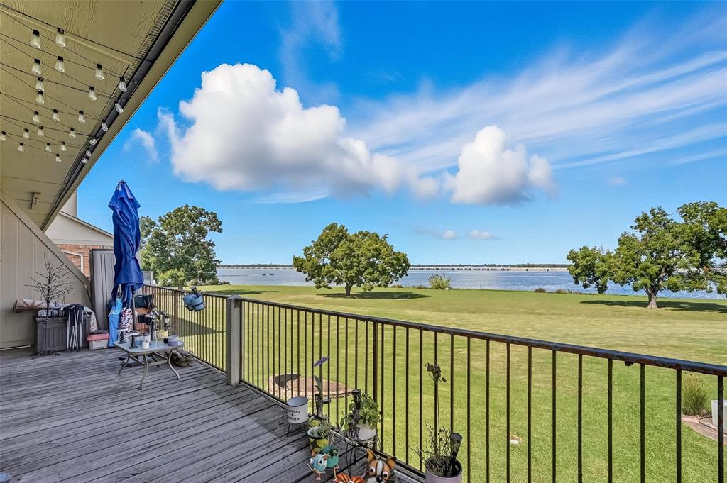 1904 Signal Ridge Place Rockwall, TX 75032 - Photo 4 of 23 Wooden terrace with a water view and a lawn