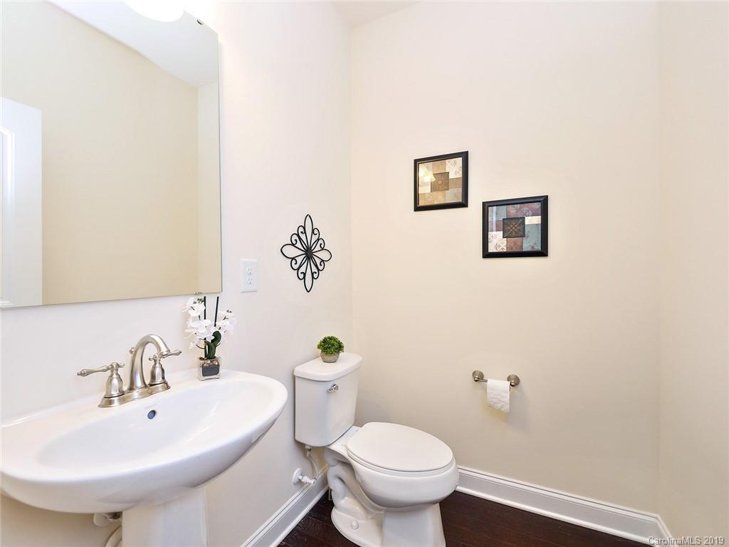 7817 Pope Farm Road Charlotte, NC 28269 - Photo 13 of 26 a bathroom with a toilet sink and mirror